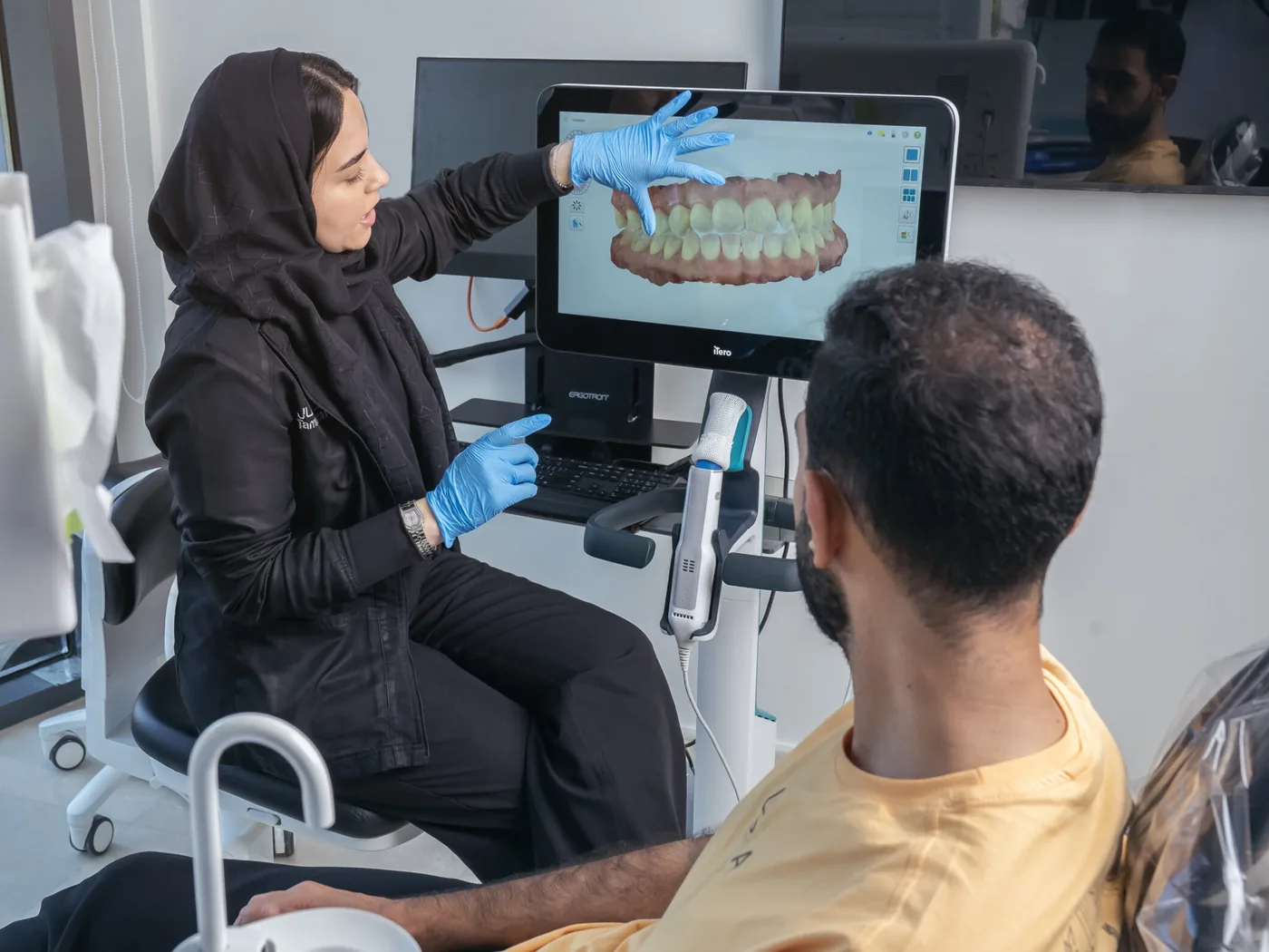 Tam Dental team using digital iTero scanning technology with a patient